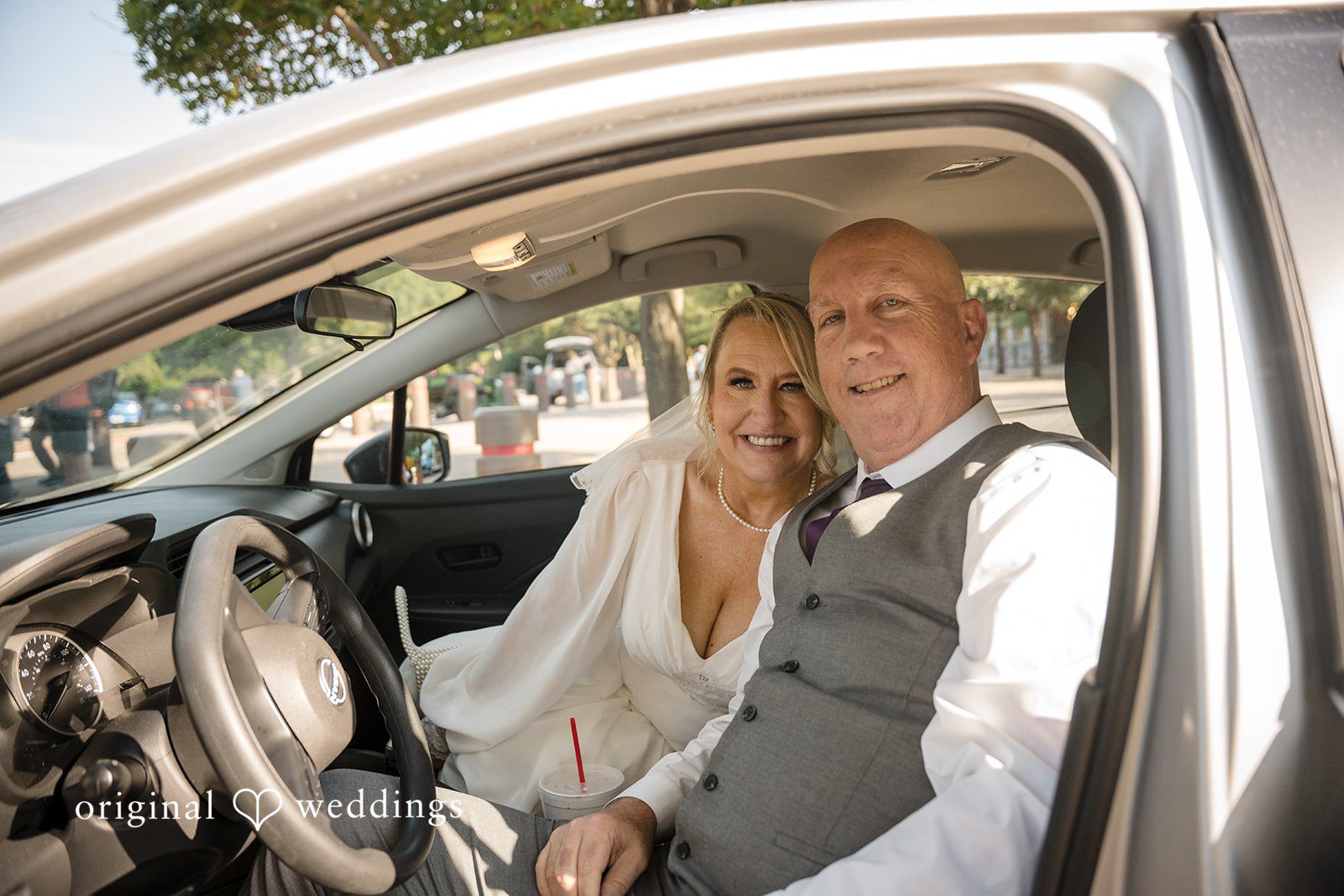 Lorene + Brad Bride and groom sharing a final portrait inside a car