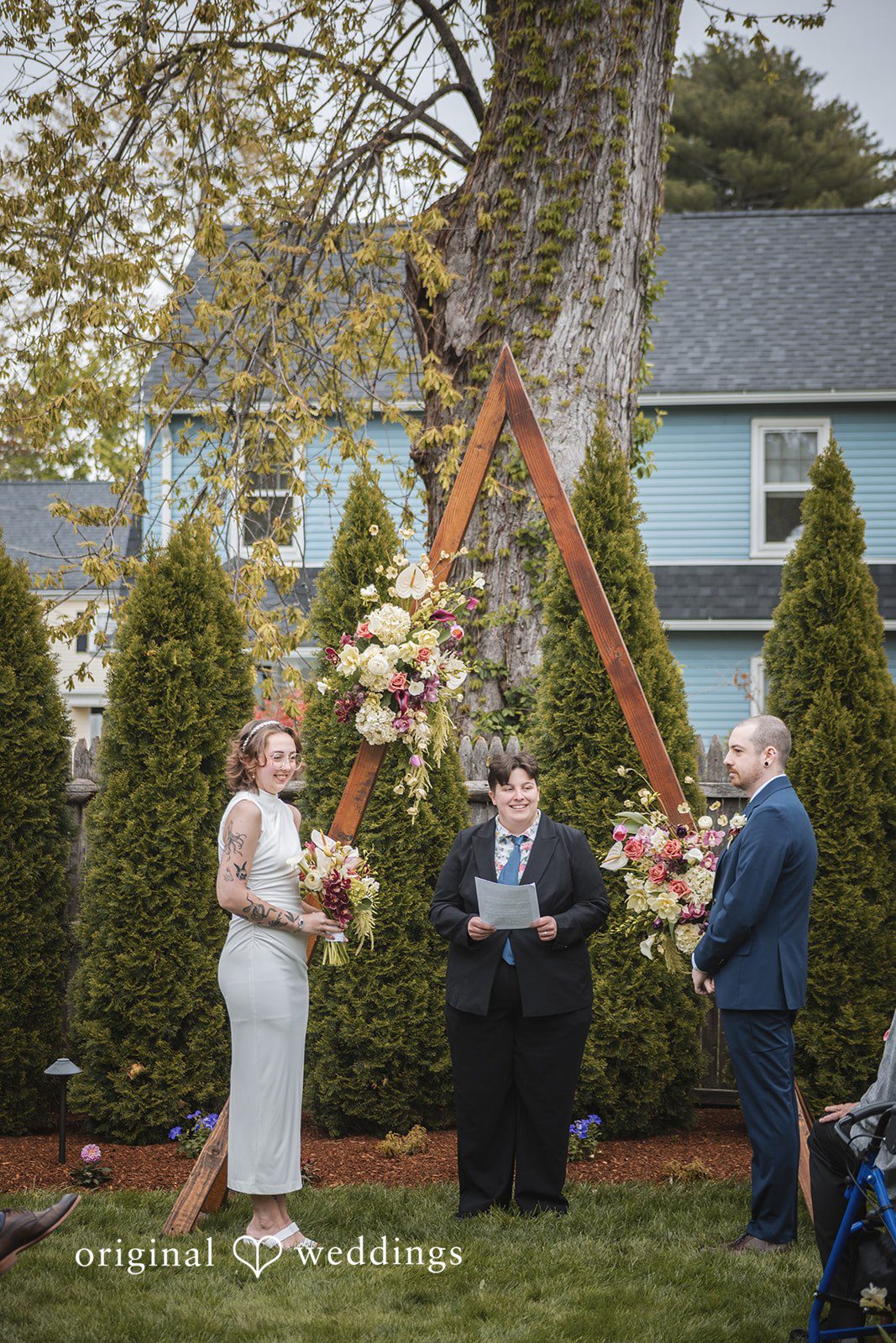 Matthew + Katie Couple holding bouquets while listening during the ceremony