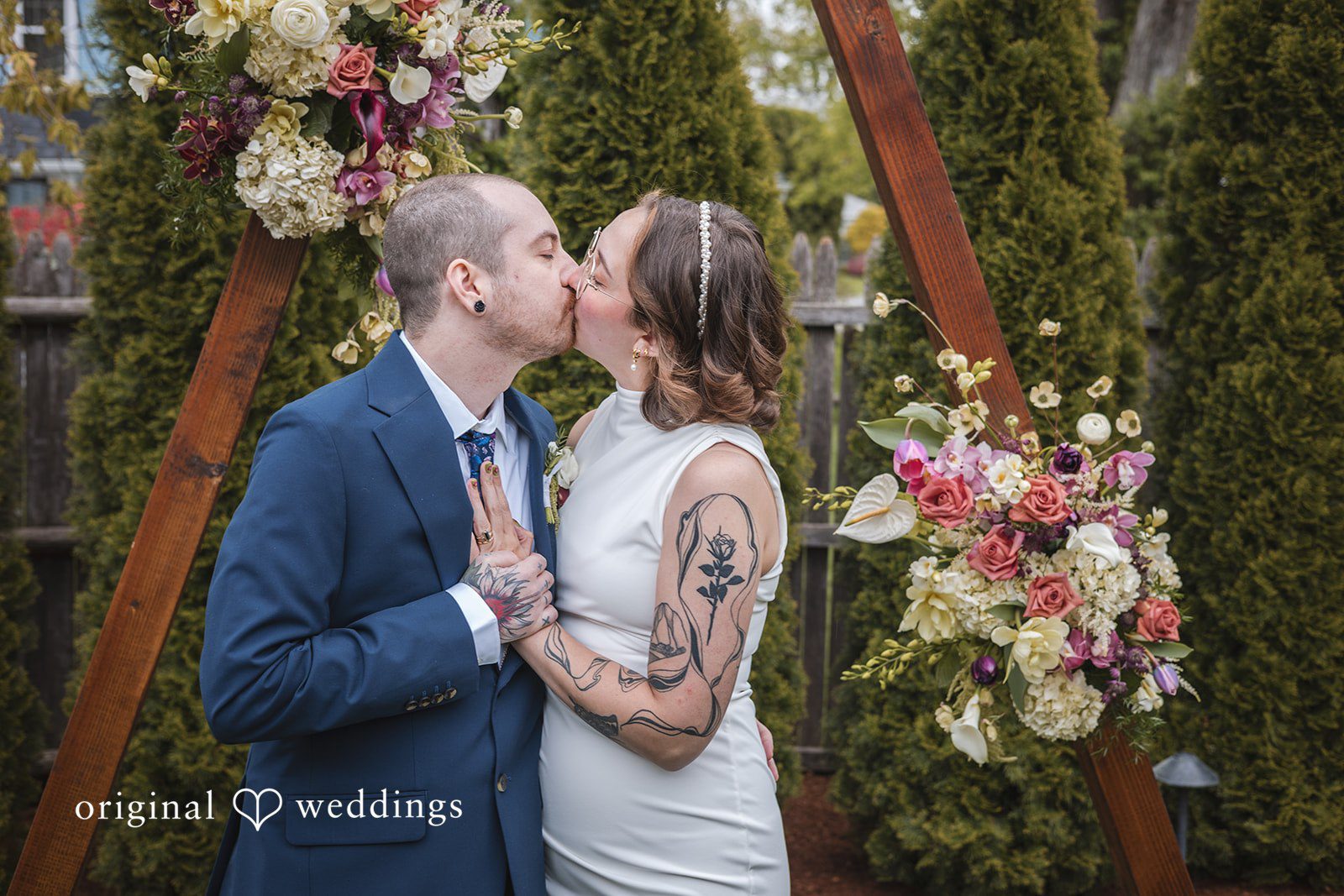 Matthew + Katie Couple sharing their first kiss during the wedding ceremony
