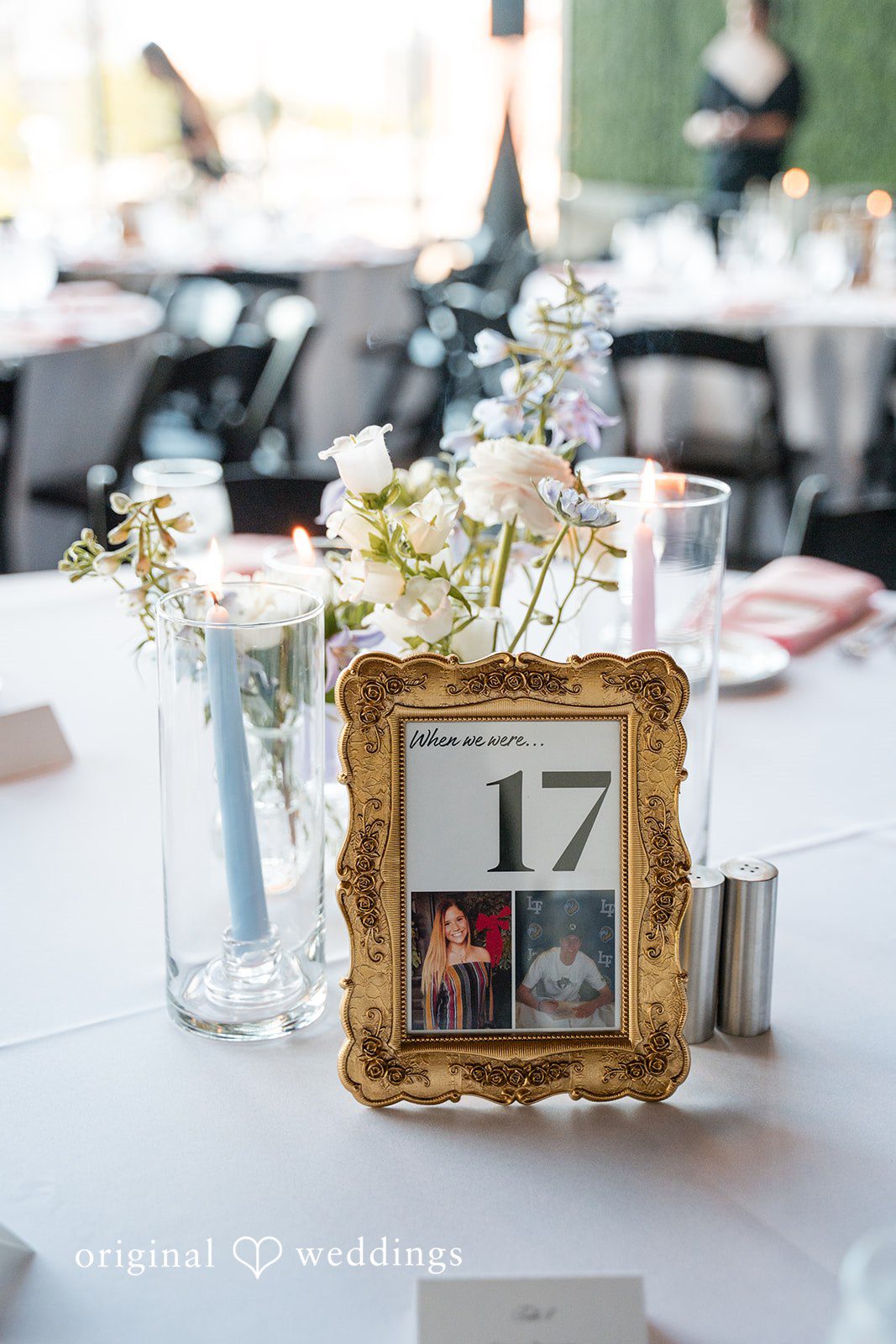 Framed table number 17 centerpiece with candles and flowers at wedding reception