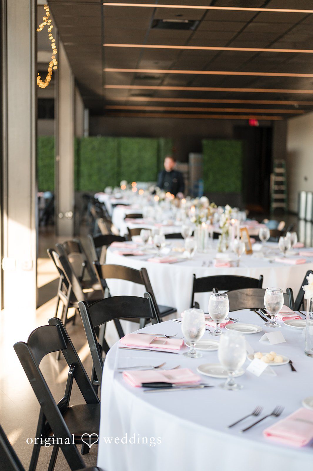 Reception tables set for guests inside Gather at Deer District with soft natural lighting
