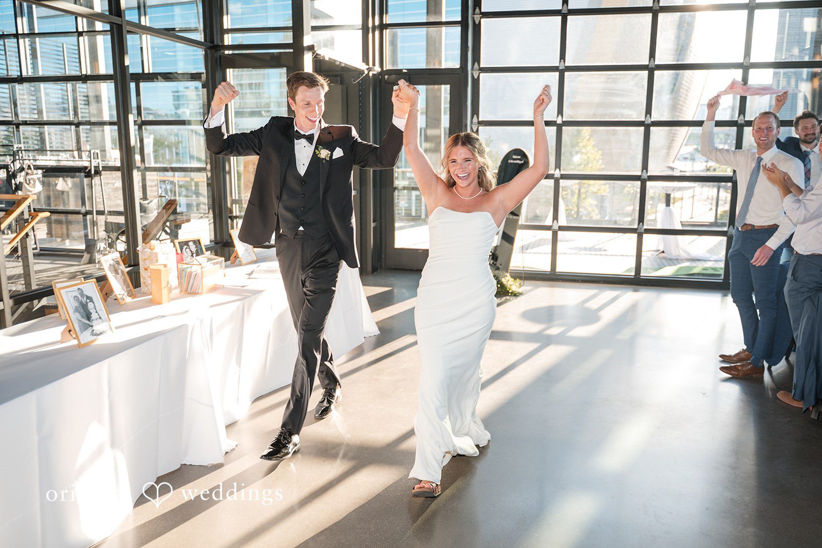 Lovely couple entering the hall for wedding reception with full joy