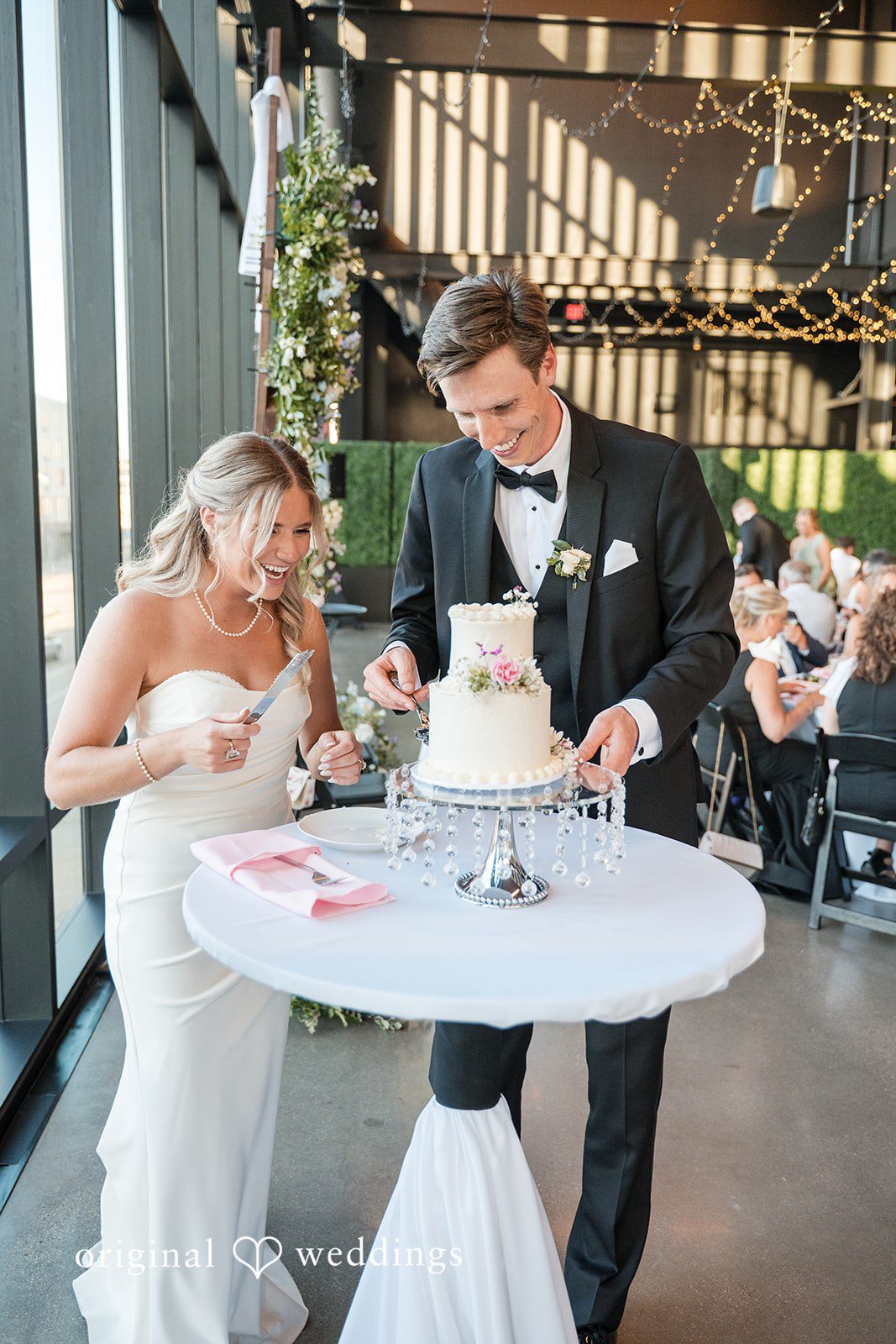 Lovely couple cutting their wedding cake with happiness