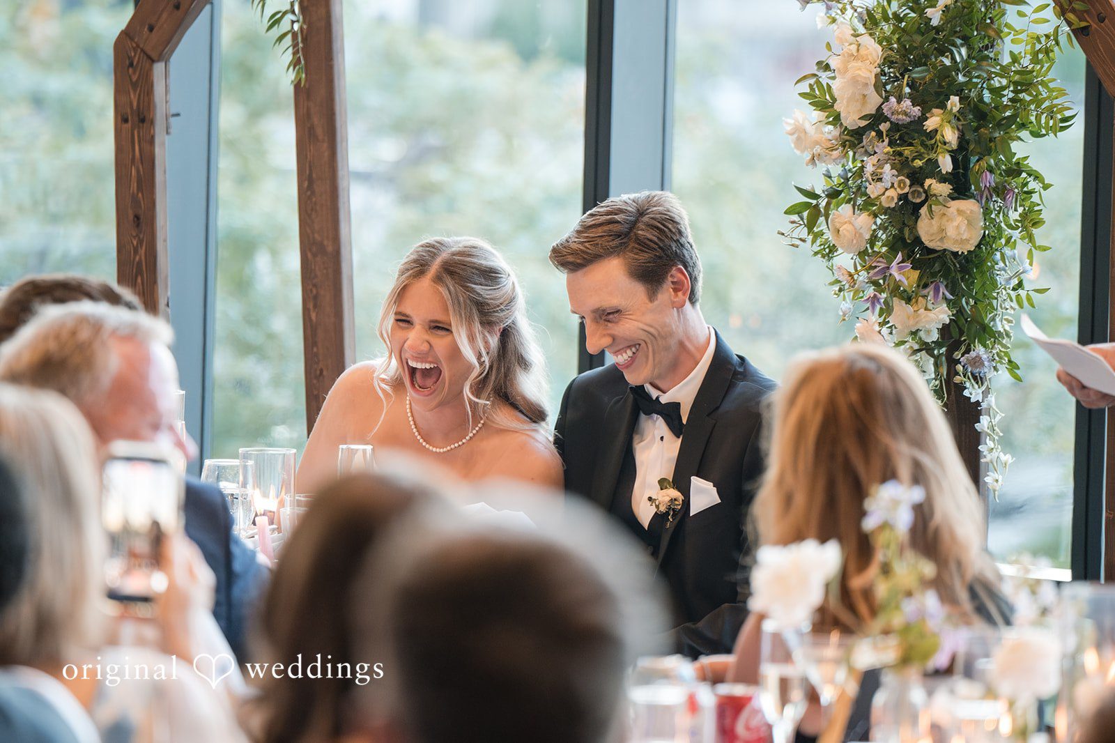 Couple having fun time with guests at reception