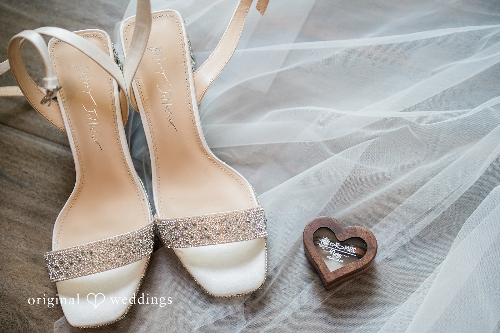 Janissa + Josh Amazing picture of bridal shoes placed on a white net