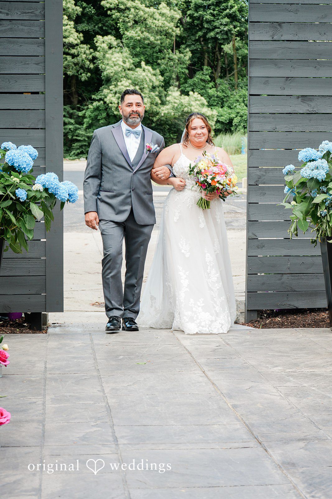 Janissa + Josh Stunning portrait of bride walking down the aisle with someone