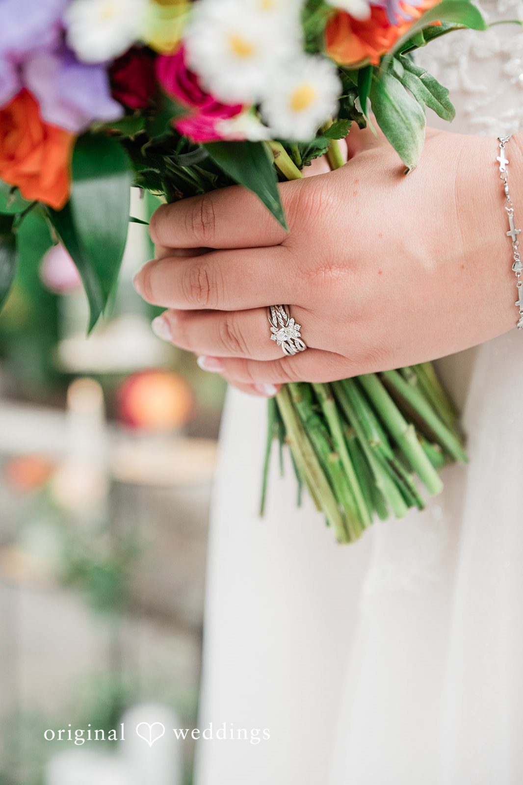 Janissa + Josh Close up shot of bride's hand with wedding ring on it.
