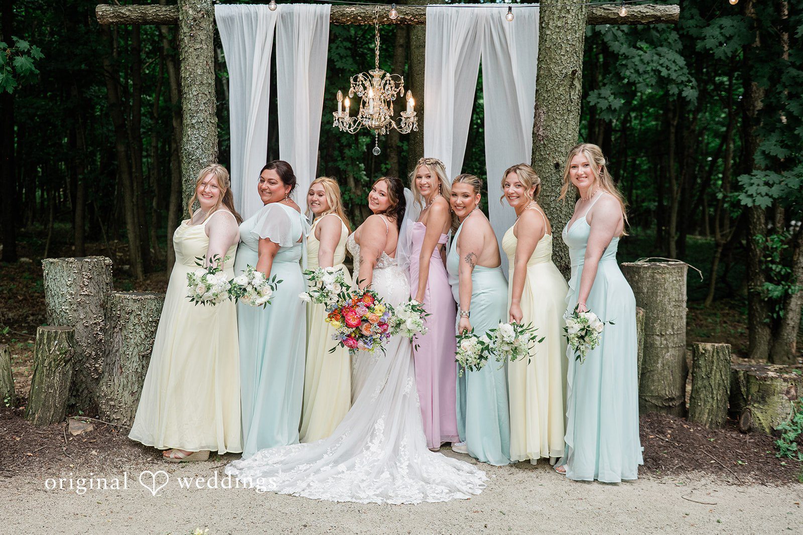 Janissa + Josh Group photo of bride with the bridesmaids, smiling and posing with bouquets in their hands