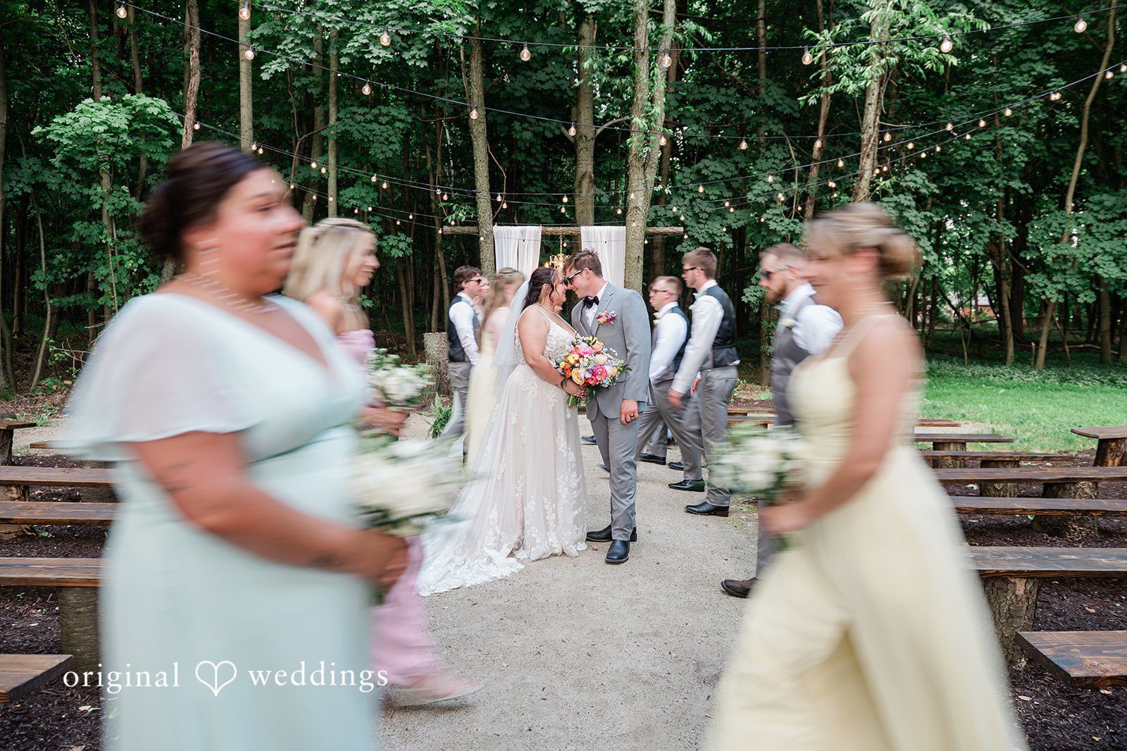 Janissa + Josh Beautiful picture of couple around the bridesmaids and groomsmen