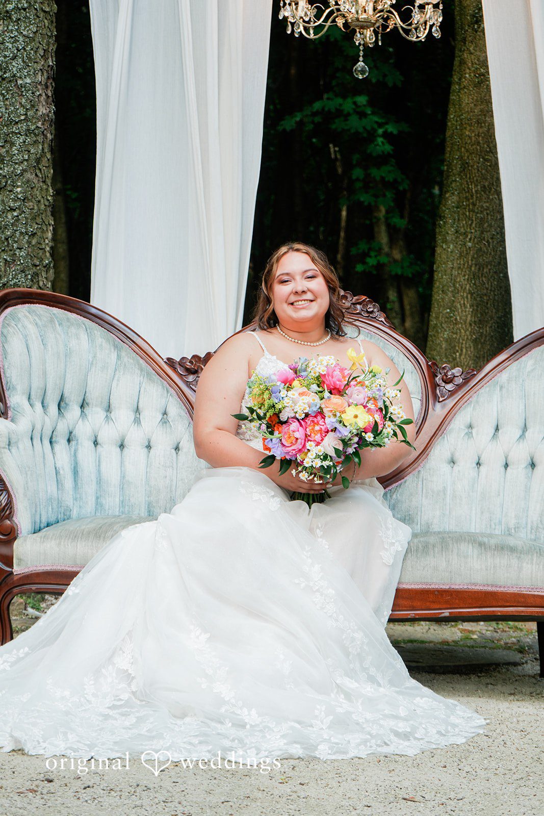 Janissa + Josh Elegant picture of bride in her wedding gown, posing with bouquet