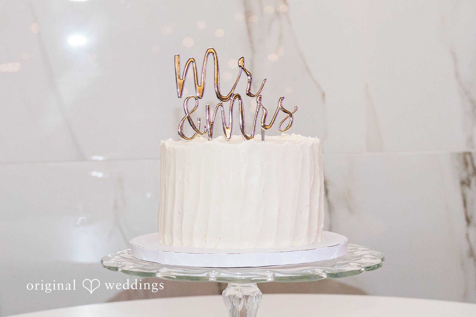 Janissa + Josh White wedding cake decorated with topper of Mr & Mrs