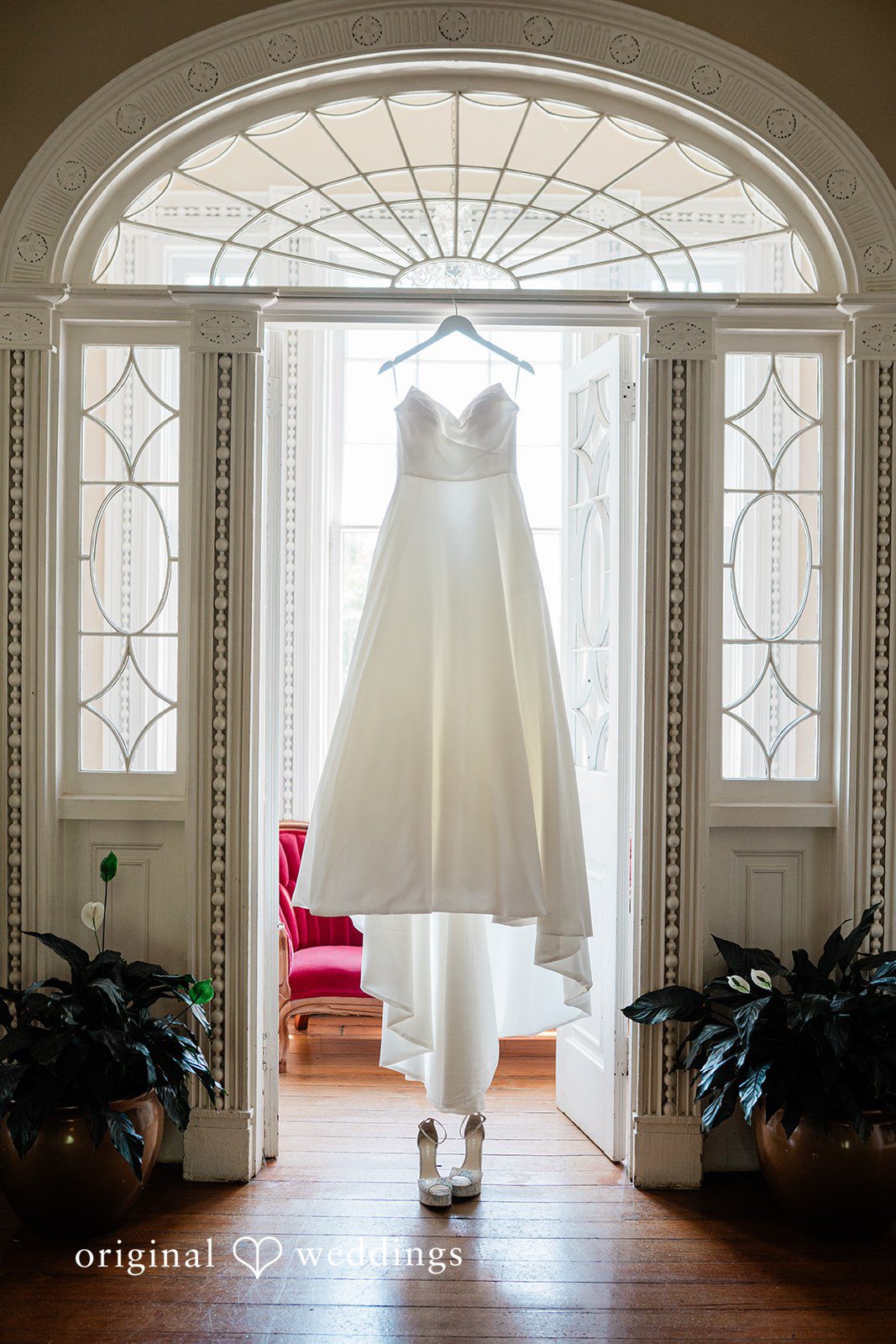The bride's gown is gracefully hanging in the suite