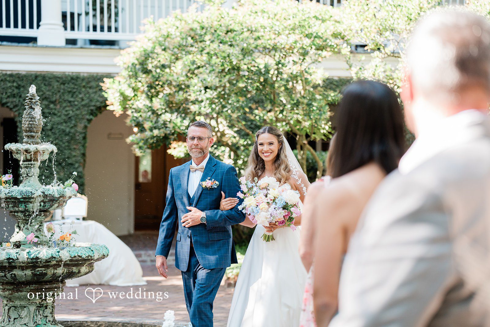 The bride's father escorts the bride down the aisle