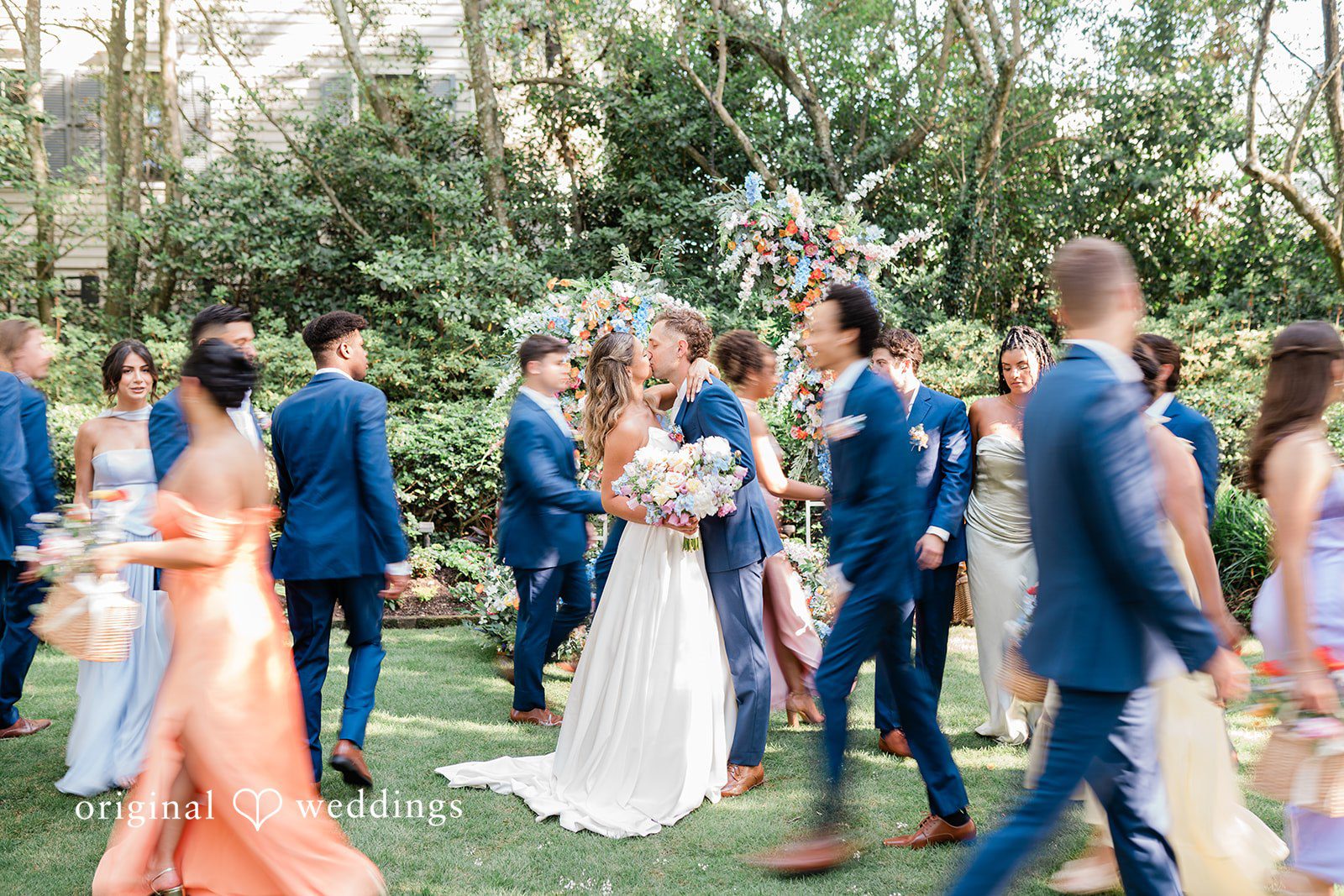 The couple takes a romantic kiss after their wedding ceremony
