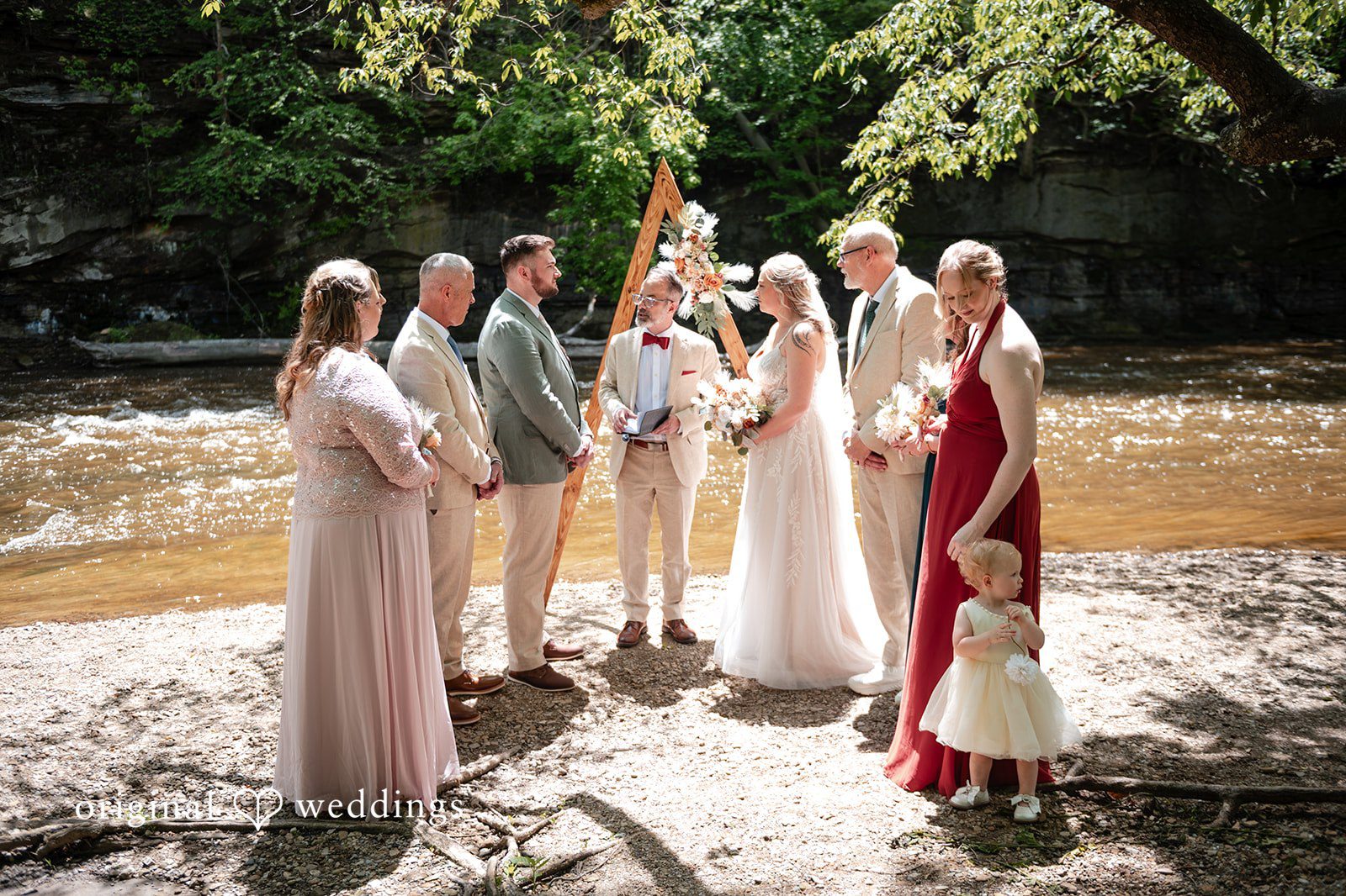 Sara + Austin Bride and groom listening to the priest during wedding ceremony at Great Falls of Tinkers Creek