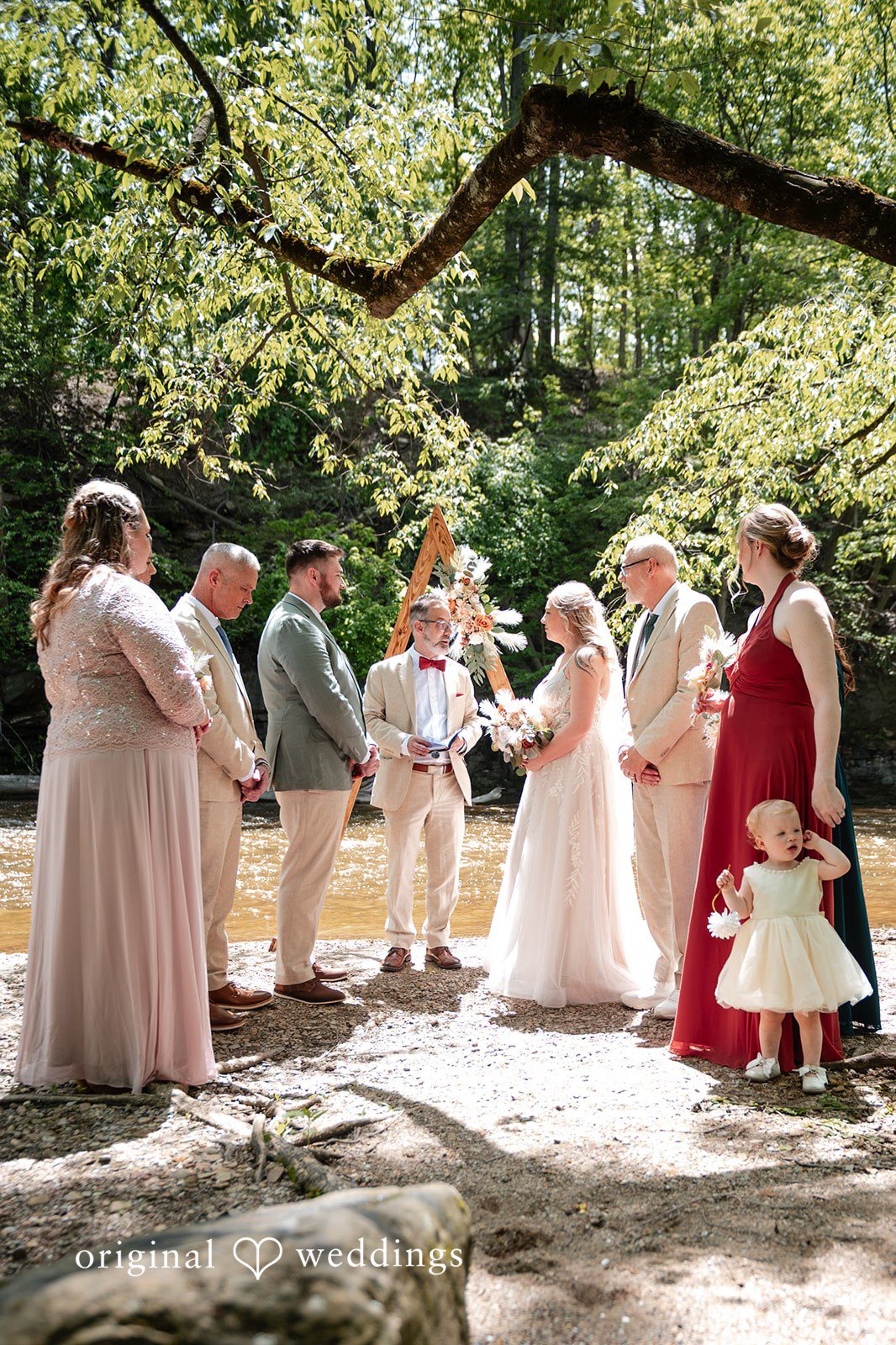 Sara + Austin Bride and groom listening to the priest during wedding ceremony at Great Falls of Tinkers Creek