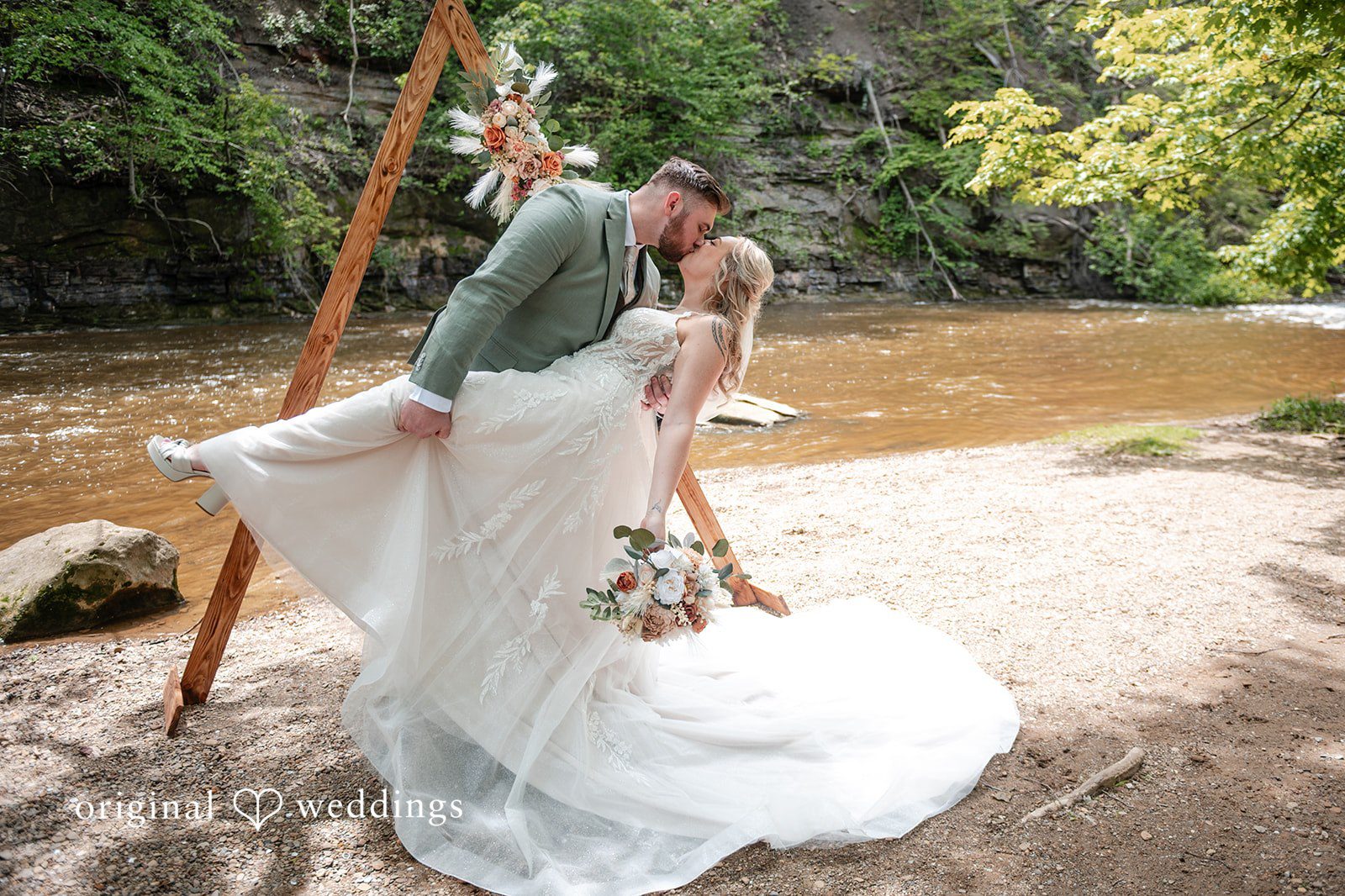 Sara + Austin Romantic kiss moment of couple at the altar at Great Falls of Tinkers Creek