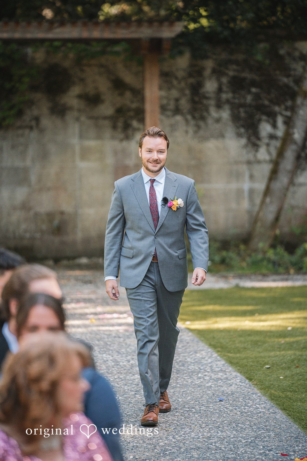 Raena + Austin The groom walks down the aisle