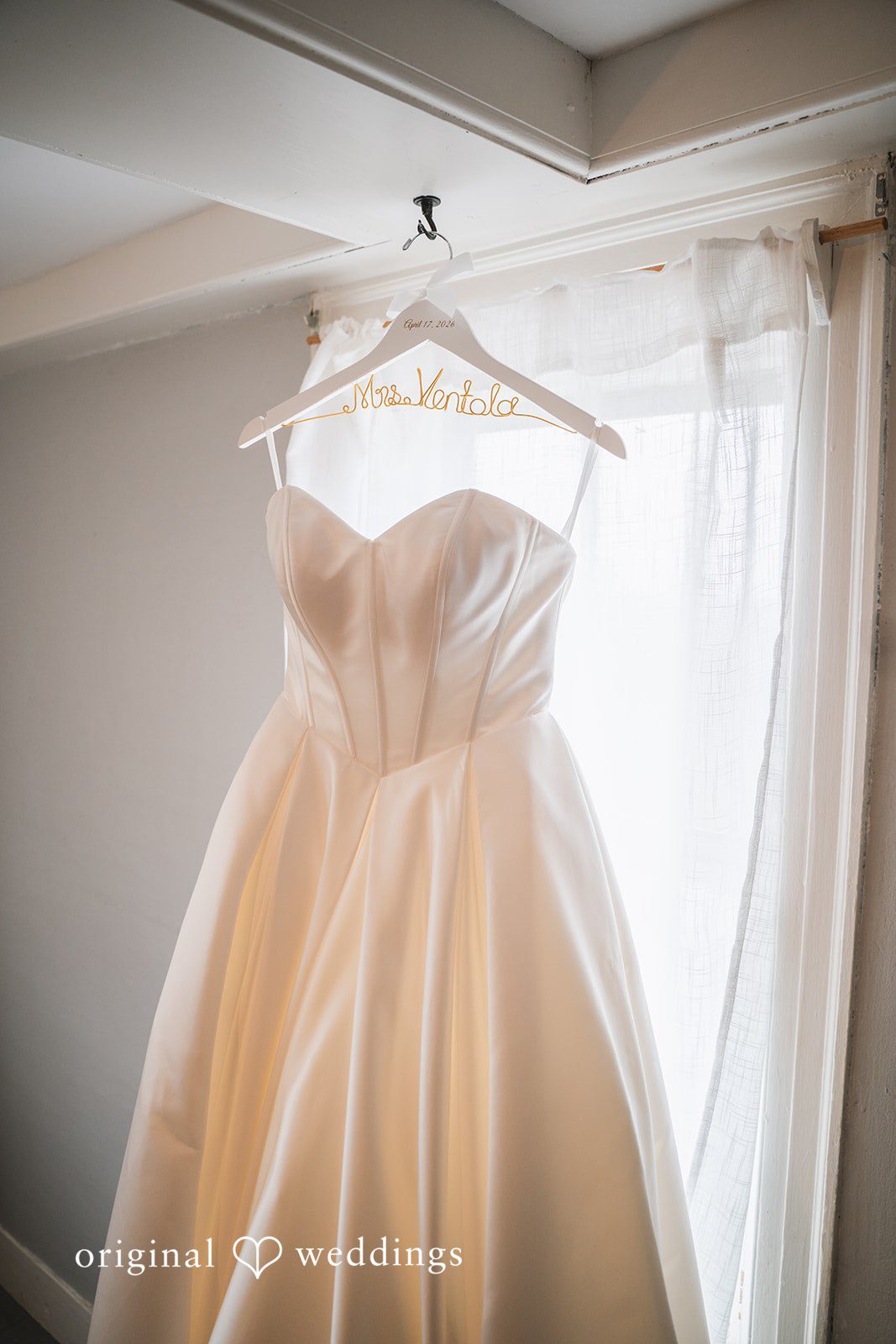 Shea + Peter The bride's gown is gracefully hanging at the suite