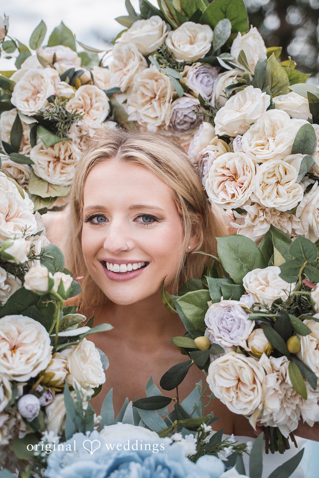 Shea + Peter A stylish portrait of the bride wrapped in blooms