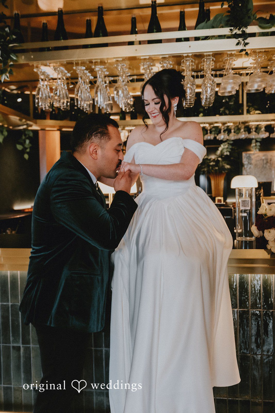 Christina + Josue The groom kisses the bride's wrist