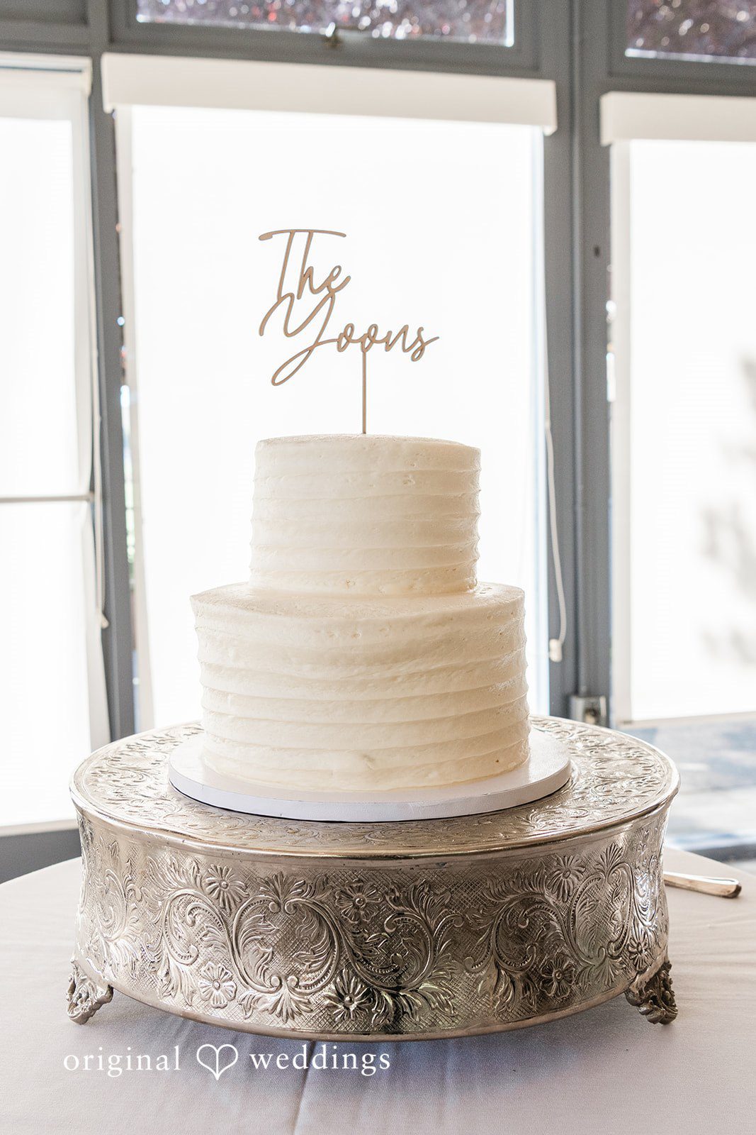 White wedding cake decorated with a topper at Hiddenbrooke Hills wedding