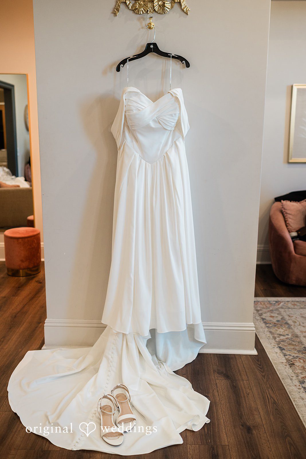 Beautiful wedding gown hanged across a wall