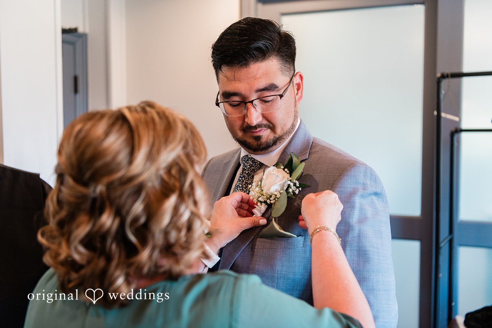 Getting ready picture of groom with a woman