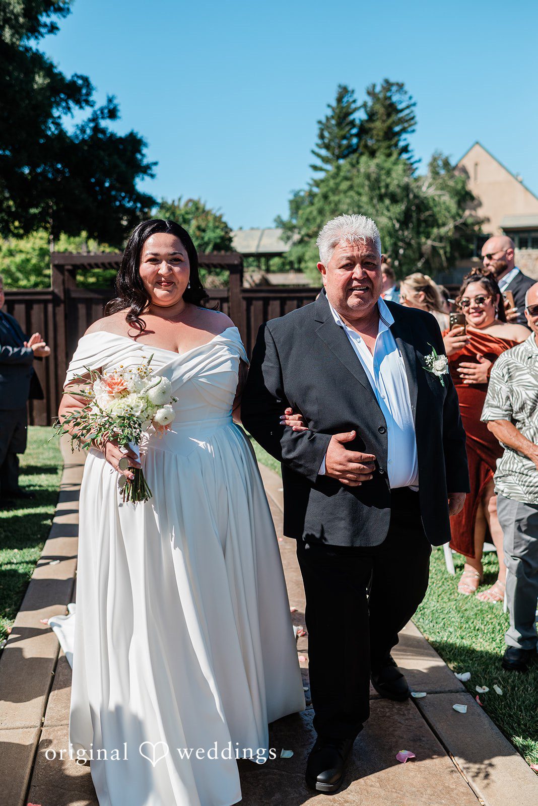 Lovely bride walking down the aisle with a man