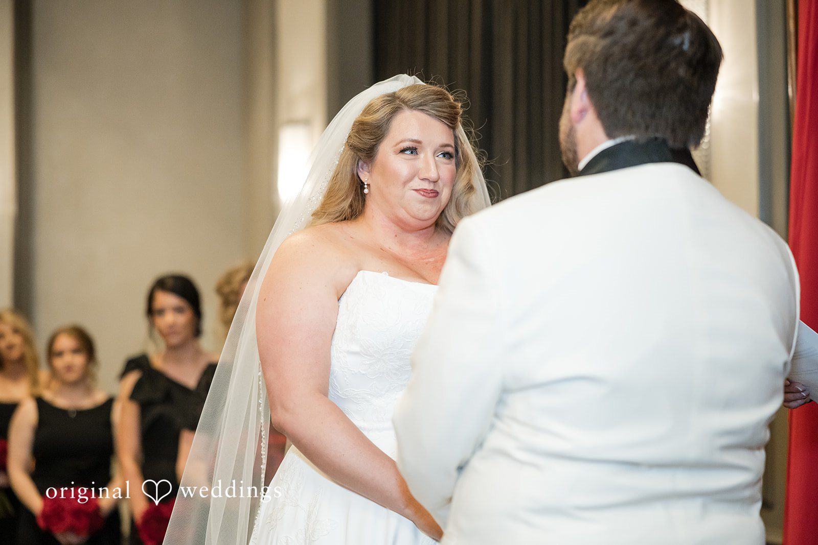 Medium shot of the bride and groom facing each other, looking at one another.