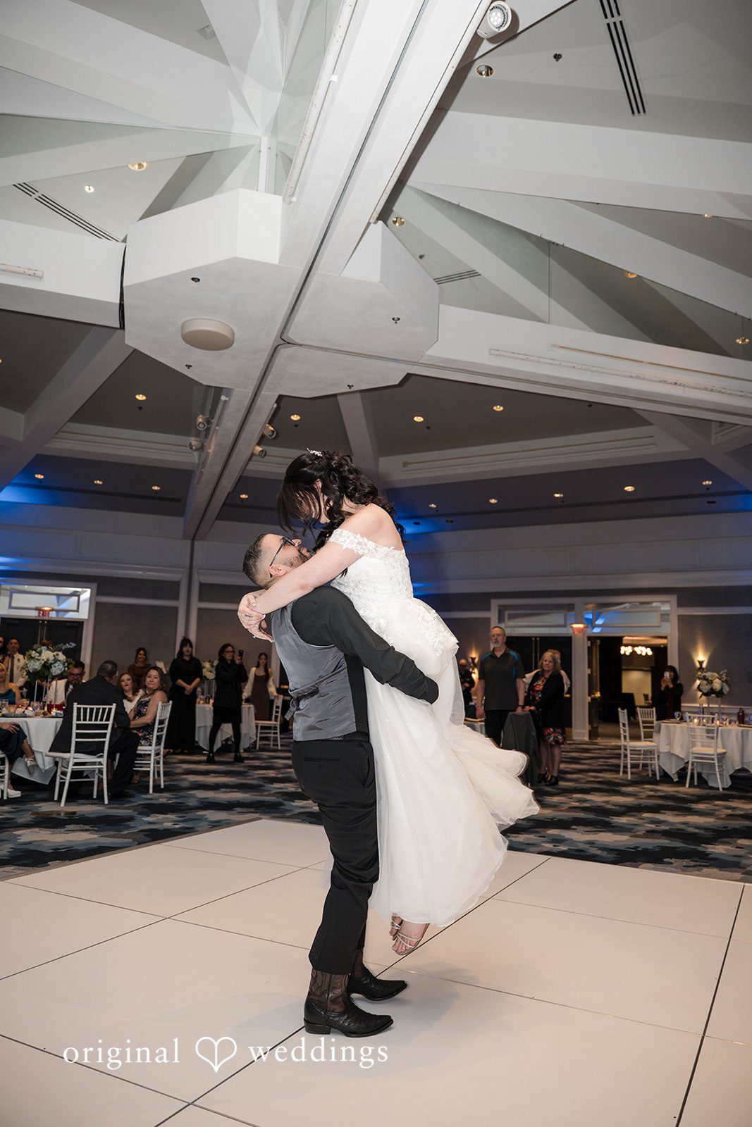 Peter + Aimee Portland Wedding Photographers capturing groom lifting bride at Hilton Portland Downtown by Original Weddings