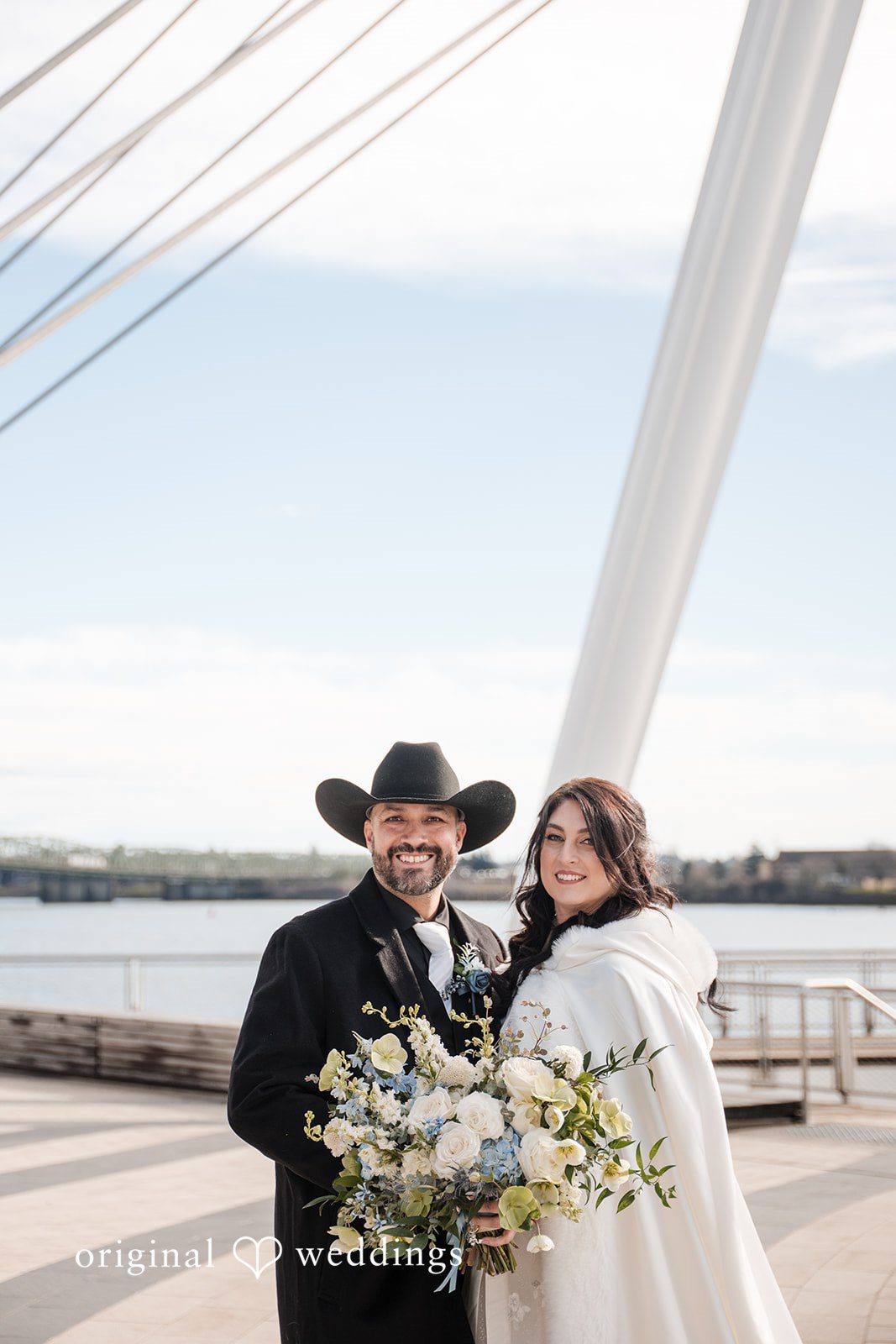 Peter + Aimee Portland Wedding Photographers capturing couple smiling while posing with bouquet at Hilton Portland Downtown by Original Weddings