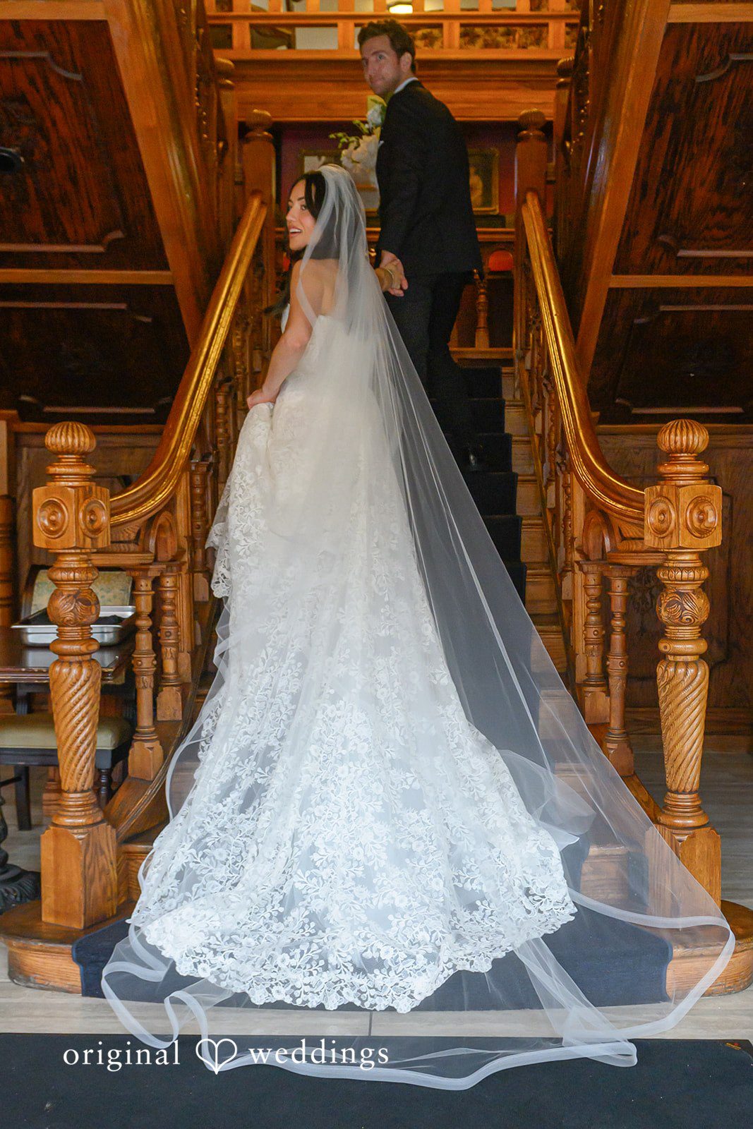 November 22, 2025 – Tabatha & Justin – (ID-4837) A bride and groom stand together on a large wooden staircase at Horton Grand Hotel.