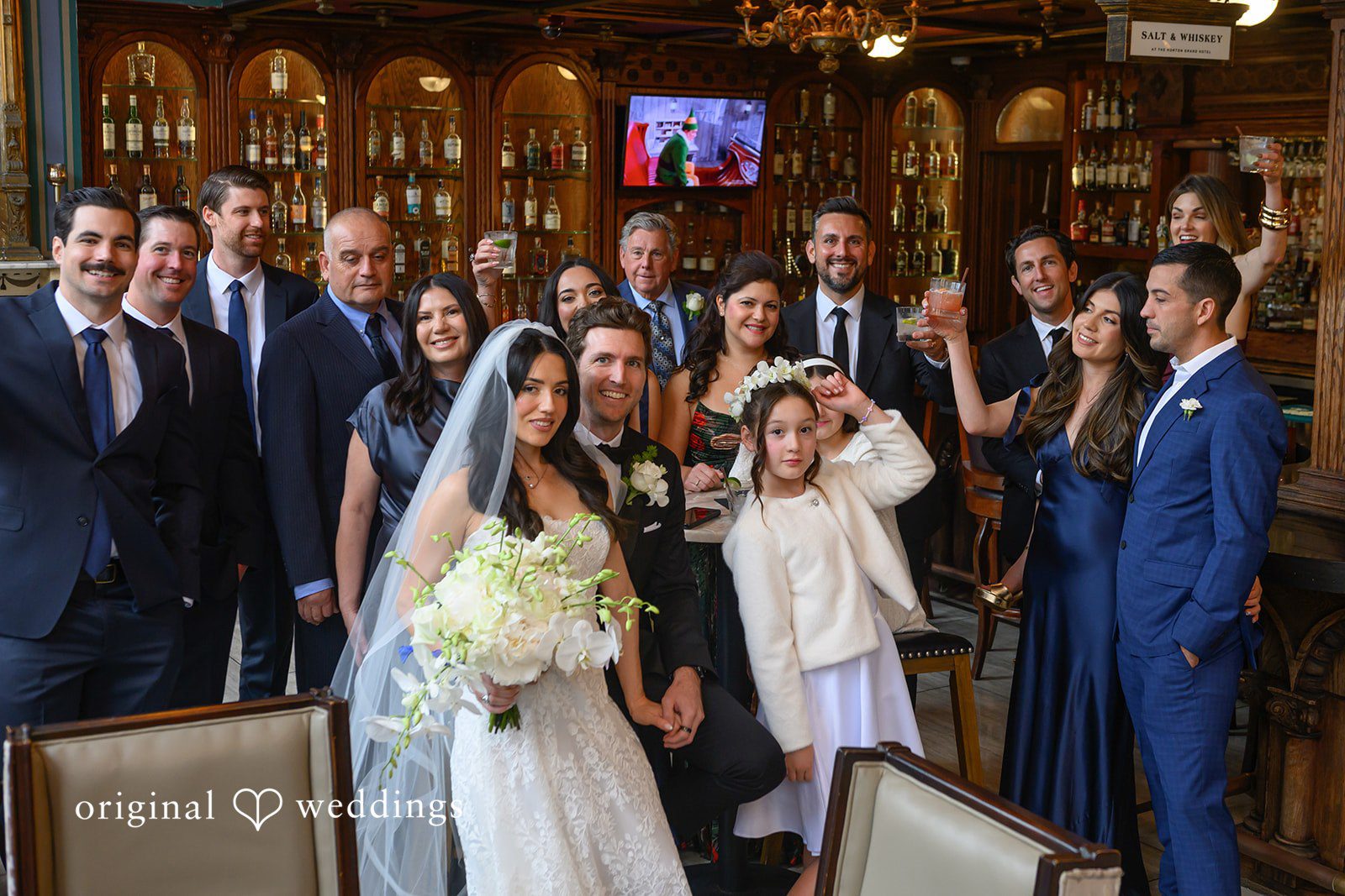 November 22, 2025 – Tabatha & Justin – (ID-4837) A large group of wedding guests and bridal party members celebrate together.
