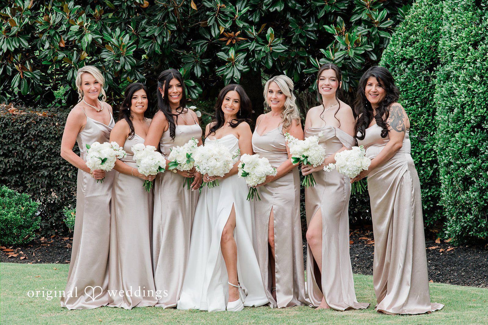 Anna + Blake Group photo of bride with the bridesmaids, smiling and posing with bouquet
