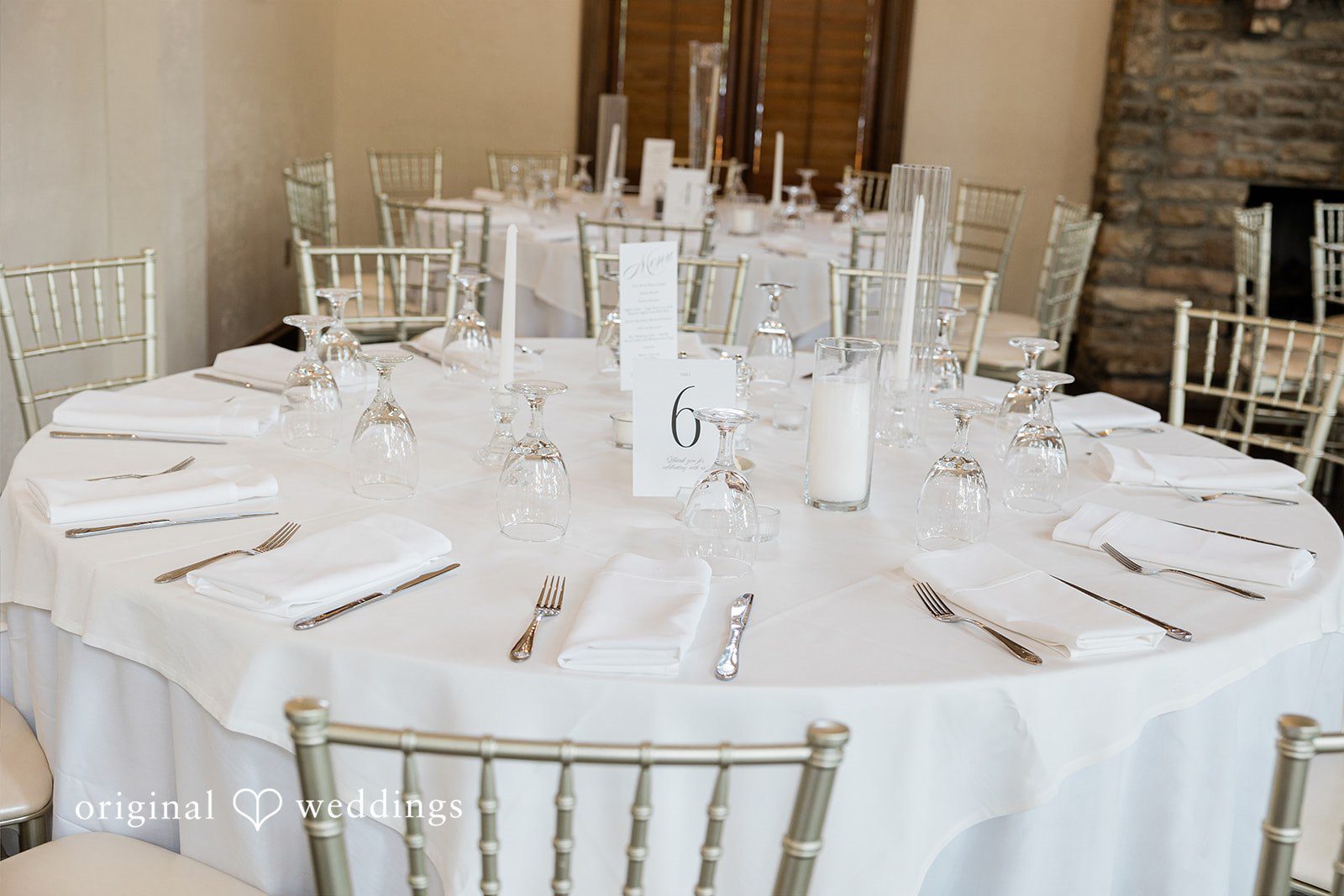 Anna + Blake Wedding table decorated and arranged with table number and tableware.
