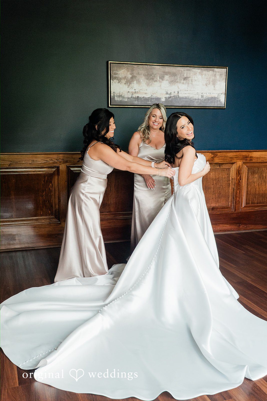 Anna + Blake Bride getting ready with help of bridesmaids happily at Iron Horse Golf Club