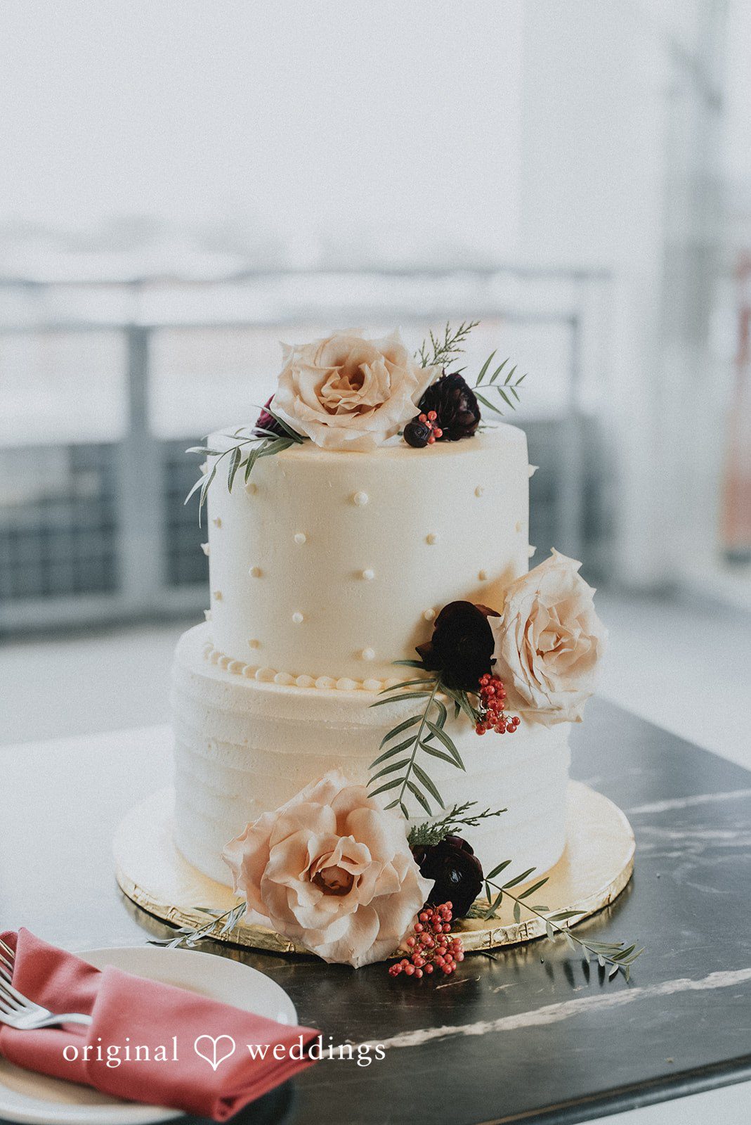 Spencer + Hilary An all-white wedding cake adorned with fresh florals