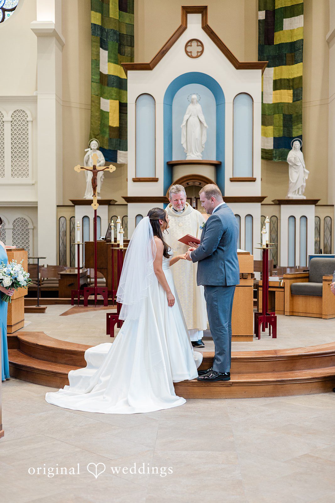 The groom puts a ring on the bride's finger