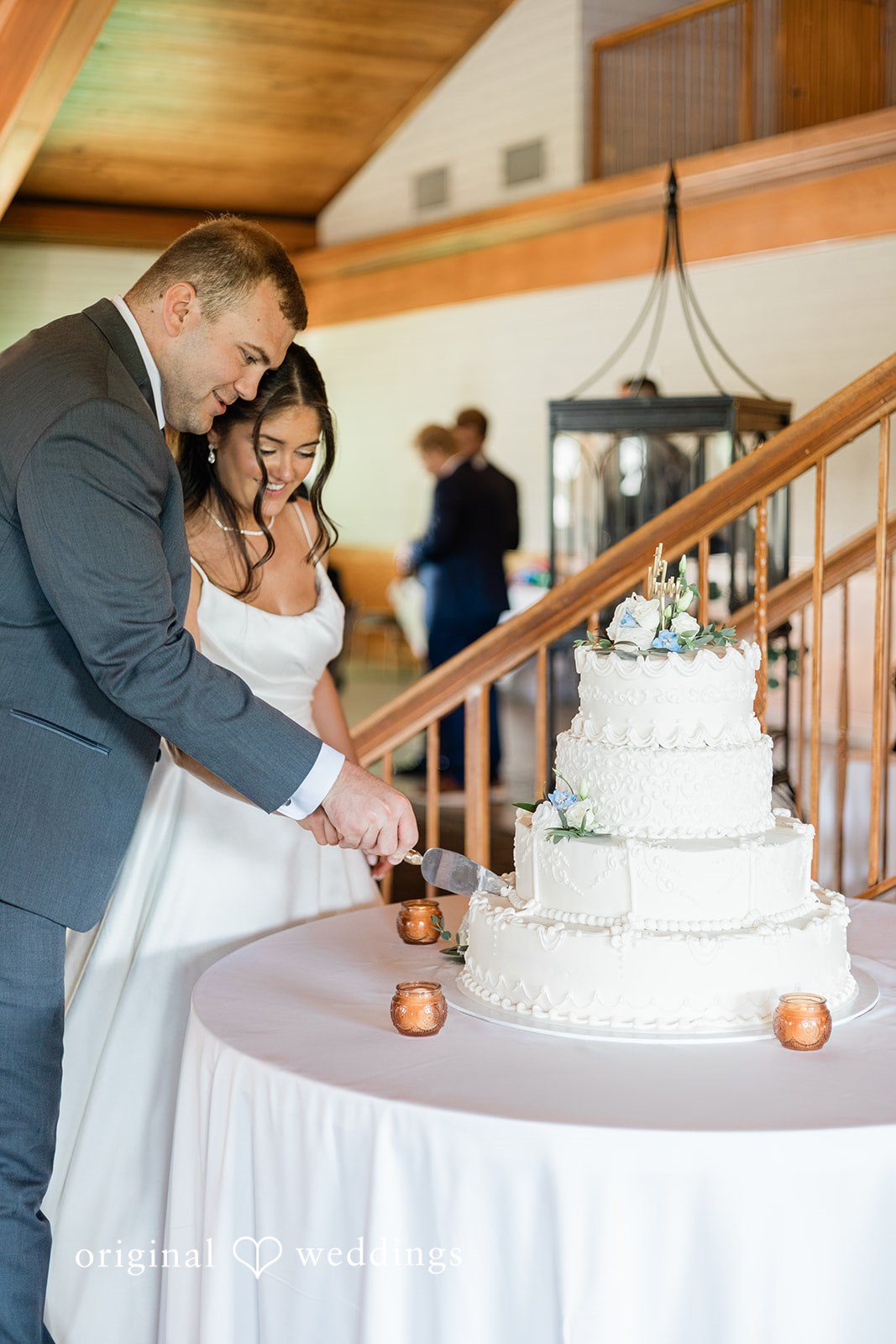 The couple cuts their wedding cake