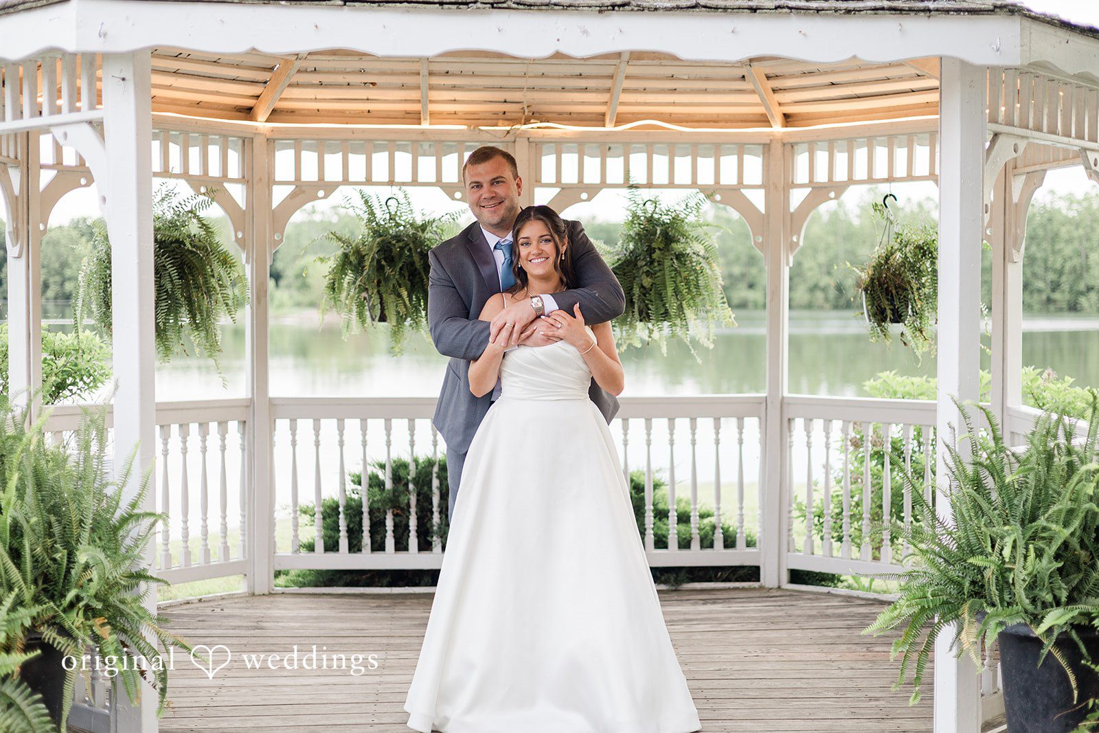 A romantic portrait of the couple by the gazebo