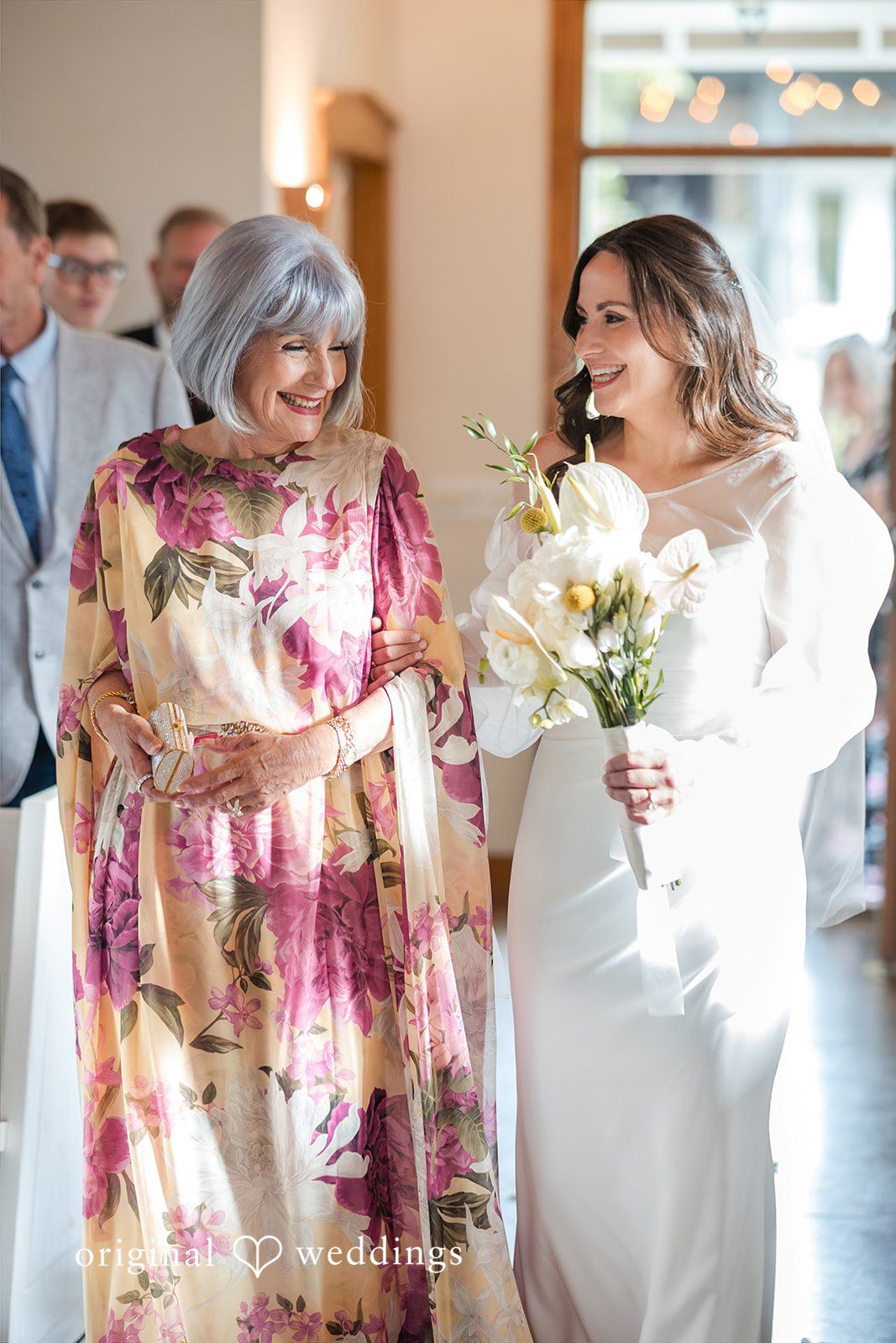 Bride looking at her flowers with her mother