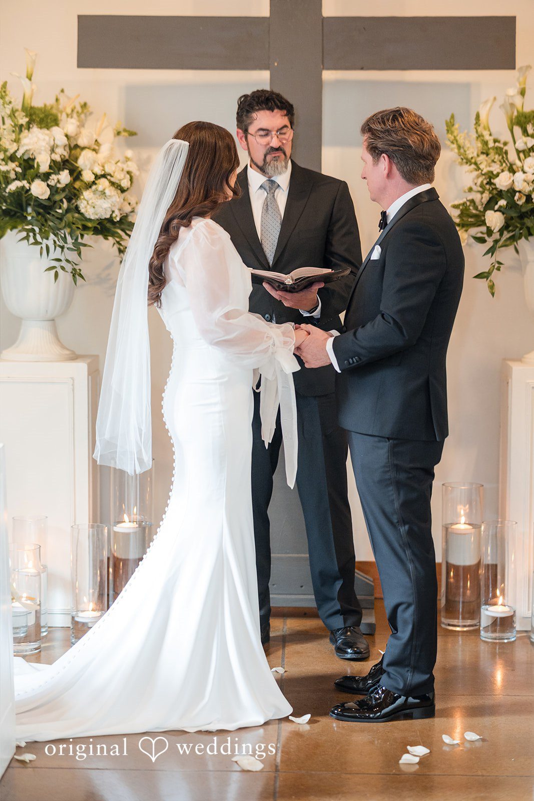 Bride and groom holding hands during the ceremony
