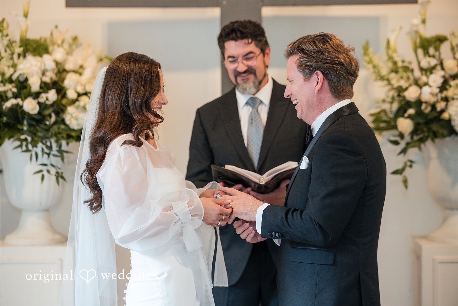 Couple holding hands while exchanging vows