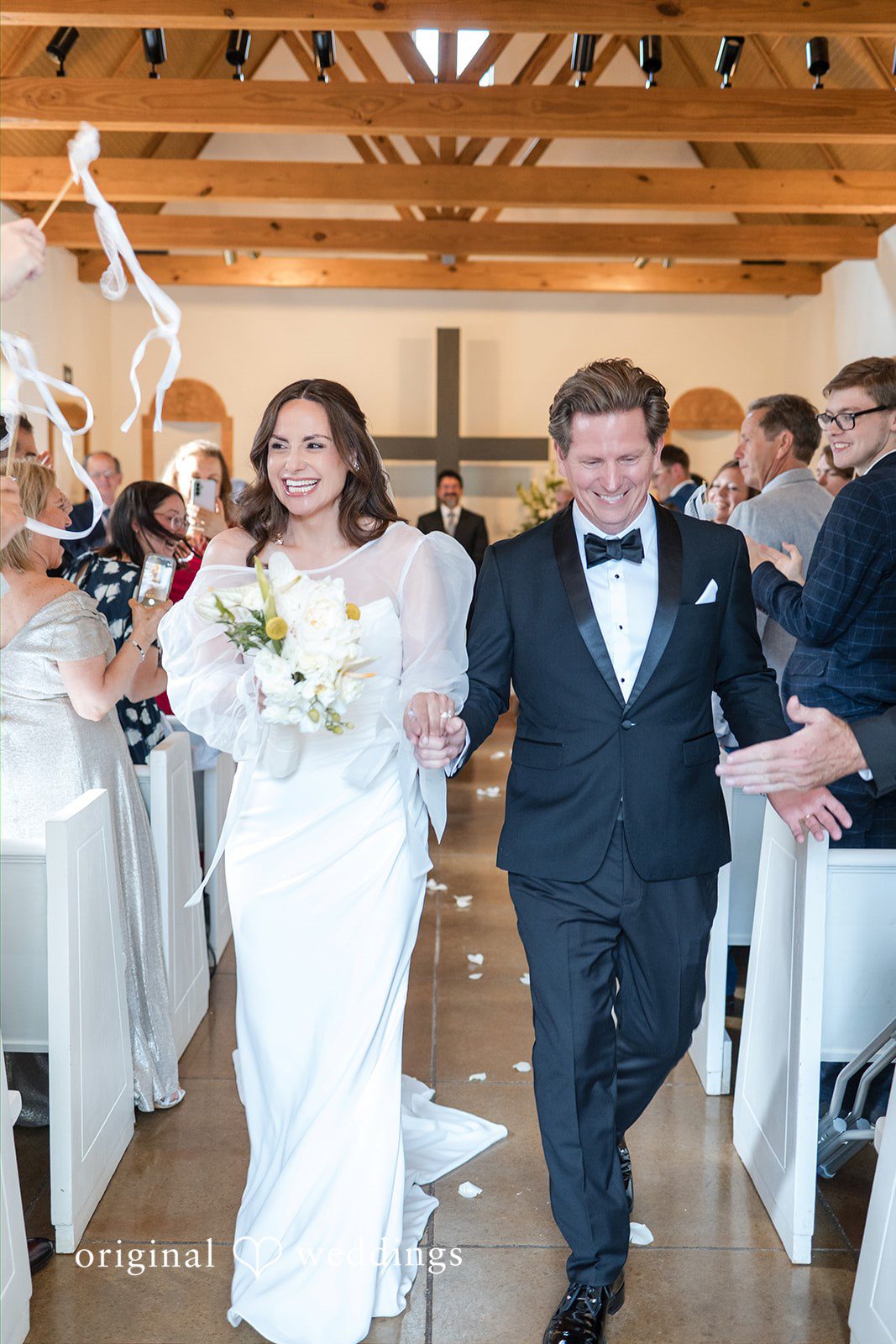 Newlyweds walking away from the ceremony area