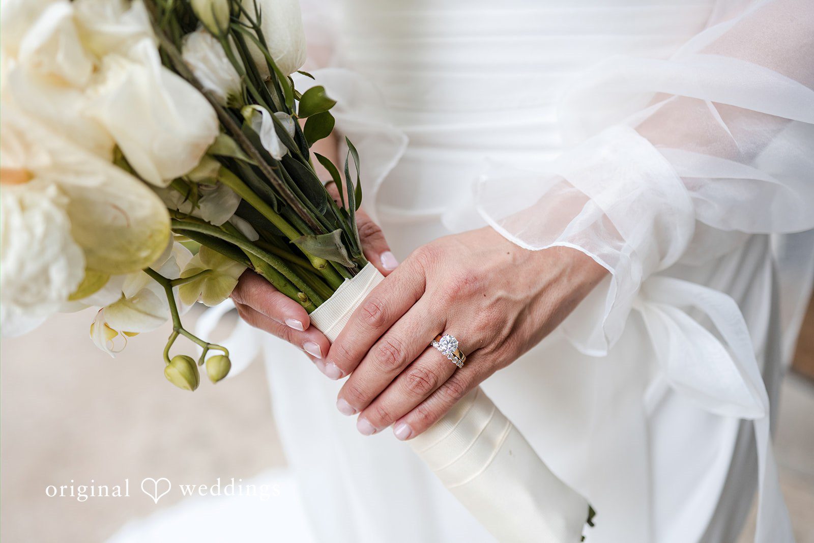 Bridal bouquet and wedding ring detail photo
