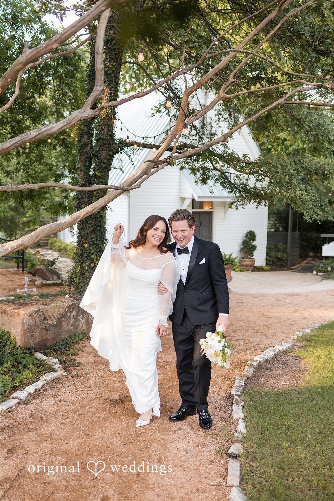 Bride and groom walking beneath the trees