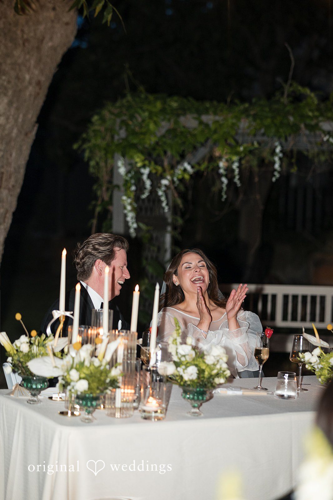Close-up portrait of the couple at their reception table