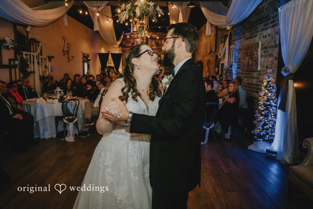 Daniel + Amanda A bride and groom dancing together as guests watch in the background.