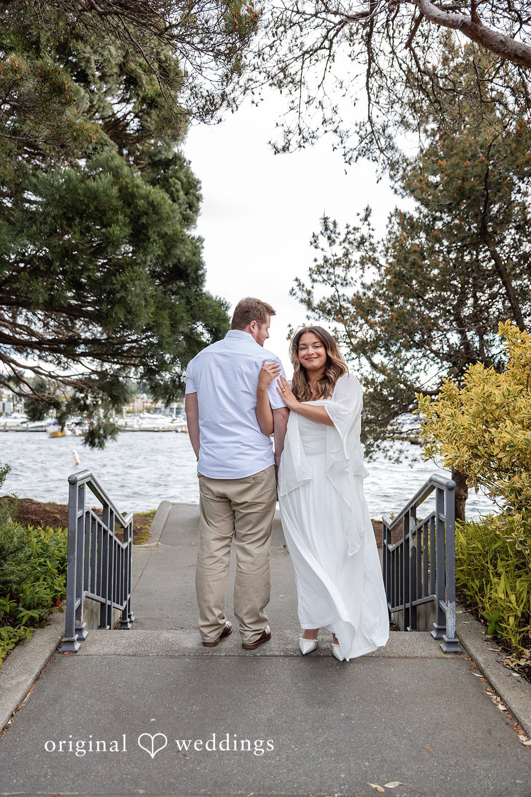 The couple takes a stylish shot at the walk path close to the water side